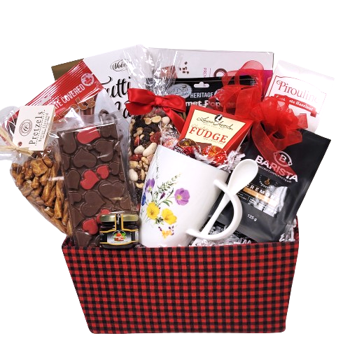 A gift basket with specialty coffee, along with a mug and snacks.