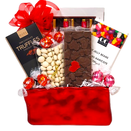 A ceramic container with chocolates and jelly beans.