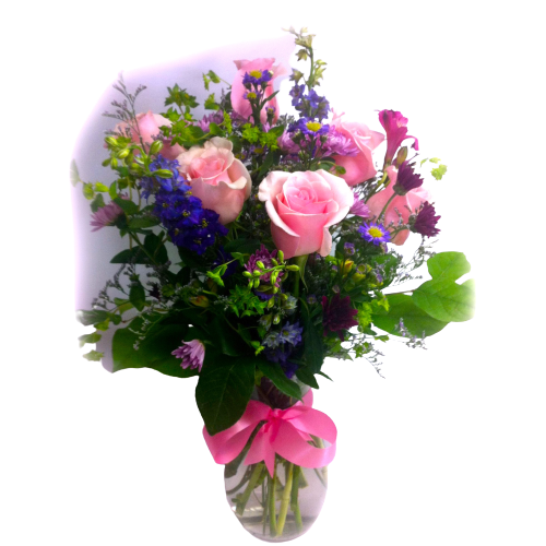 A pretty vase arrangement of roses and garden flowers in pinks and purples.