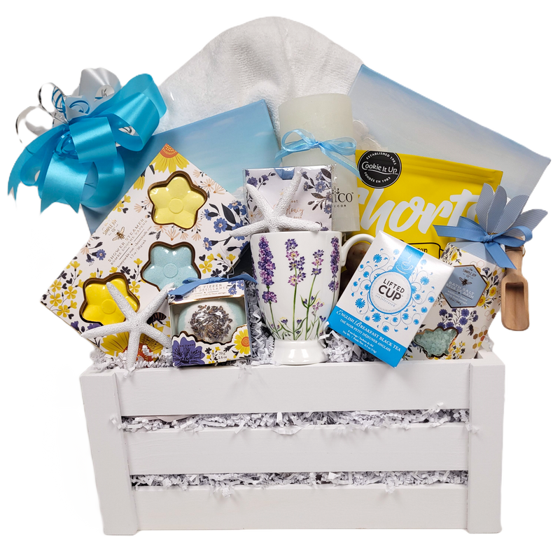 Shower steamers, a bath fizzer, bath salts, a fragrance sachet, a pillar candle, a mug, tasty shortbread, a plush bath towel, two mini ocean prints, and pretty seashells too!