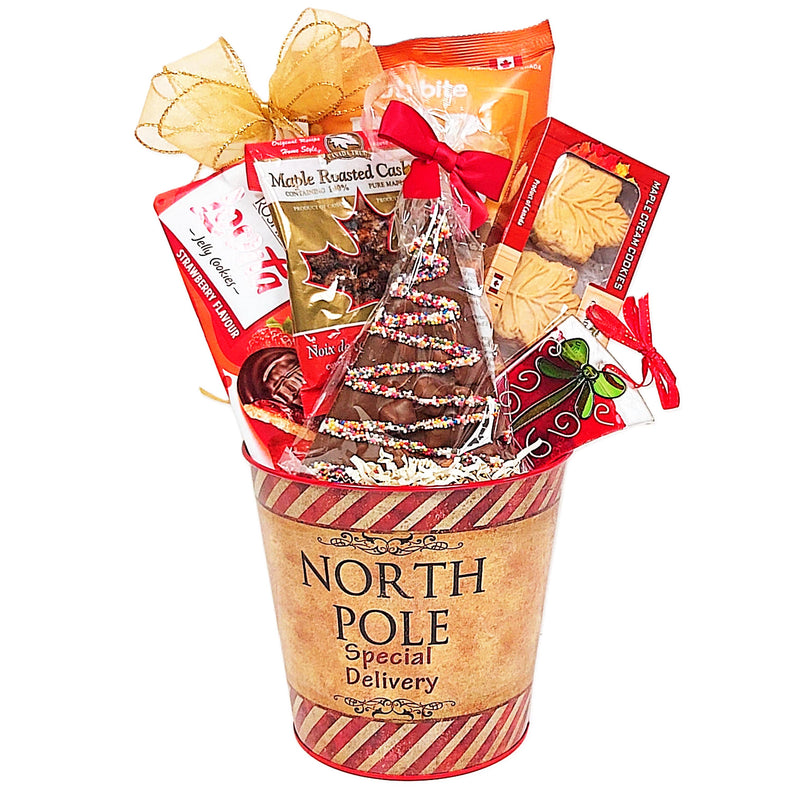 Christmas Gift Basket of of delectable sweet treats and a Christmas ornament too! There's chocolate, nuts, cookies and popcorn. A delicious assortment to enjoy.