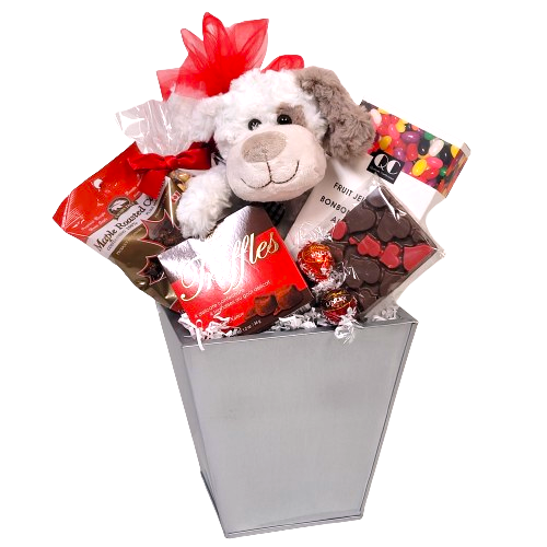 Send your hugs & kisses with this adorable basket of tasty treats to enjoy with a cute cuddly puppy all snuggled inside.