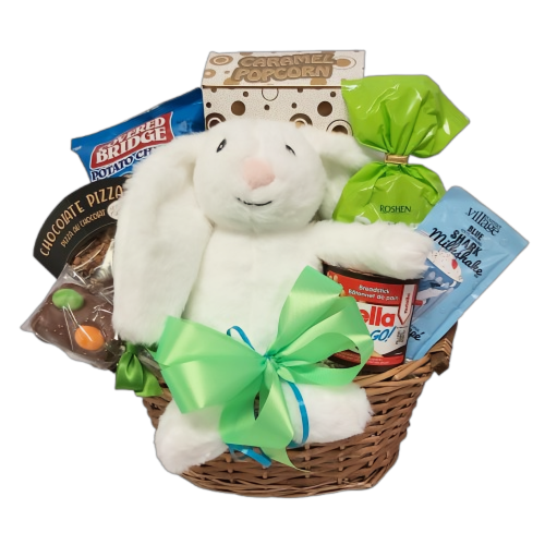 A stuffed rabbit with a chocolate pizza, caramel corn, gummy candy, chips and more in a basket.