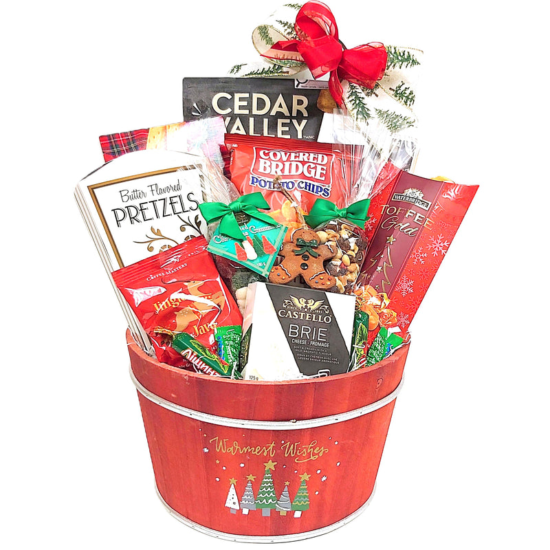 A beautiful wooden Christmas gift basket with a "warmest wishes" festive design is filled with cheese and crackers, toffee, shortbread, chips, chocolate, coffee and more along with a Christmas keepsake ornament to treasure.