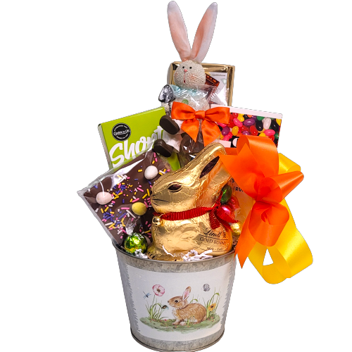 A tin pot holds a chocolate bunny, delectable shortbread, Easter chocolate bark, jelly beans, chocolate Easter eggs and a cute bunny.