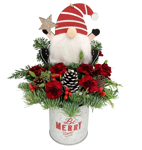 A little gnome nestled amongst long-lasting Christmas greens and florals in a rustic 'Be Merry' tin.