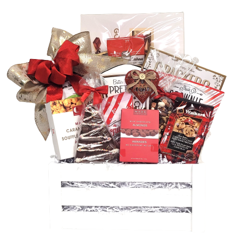 A wooden crate filled with cookies, cashews, apple chips, popcorn, pretzels, brittle, chocolate, a keepsake ornament and much more.