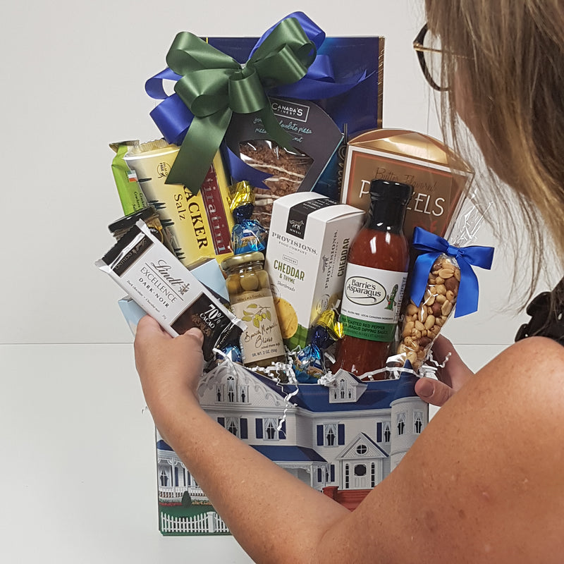 A stunning gift basket is being put together custom by one of the Baskets and Blooms Designers.