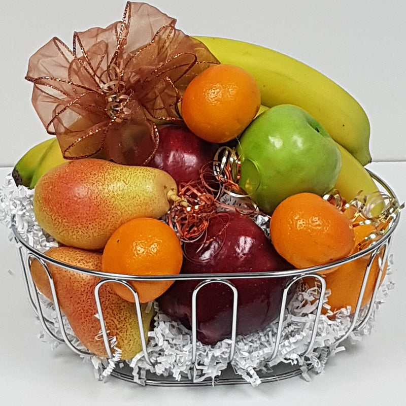 An assortment of fresh fruits arranged in a fruit basket.