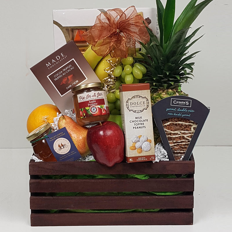 A wooden crate of fresh fruit, sweet and salty treats, specialty honey and more.