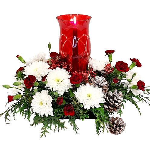 A red glass chimney with a candlestick in the center, surrounded by Christmas greenery and red & white blooms.