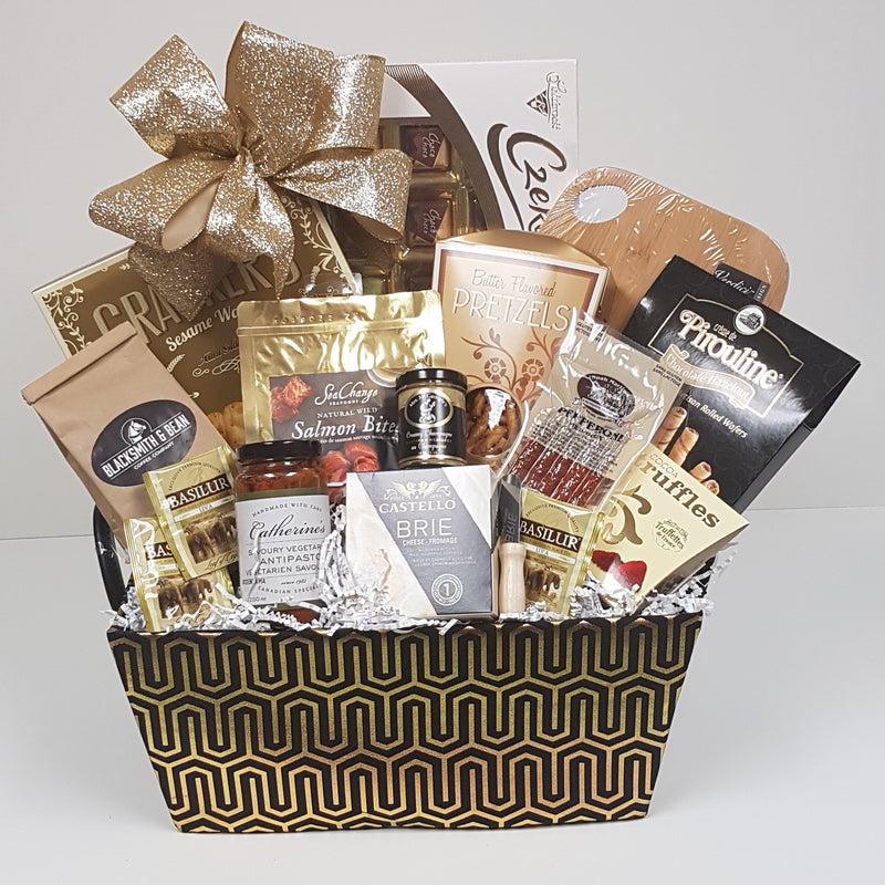 A designer basket inside is European chocolates, crackers, Brie cheese, Salmon, pretzels, a cutting board, pepperoni, coffee, antipasto, tea, mustard, and chocolate truffles.
