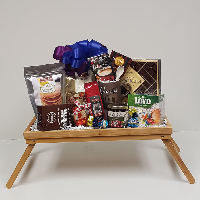 A breakfast tray loaded with flavoured hot chocolate, coffee, tea, a special mug, pancake mix and maple syrup, shortbread and biscuits and yummy "Pie in a Jar" dessert topping!