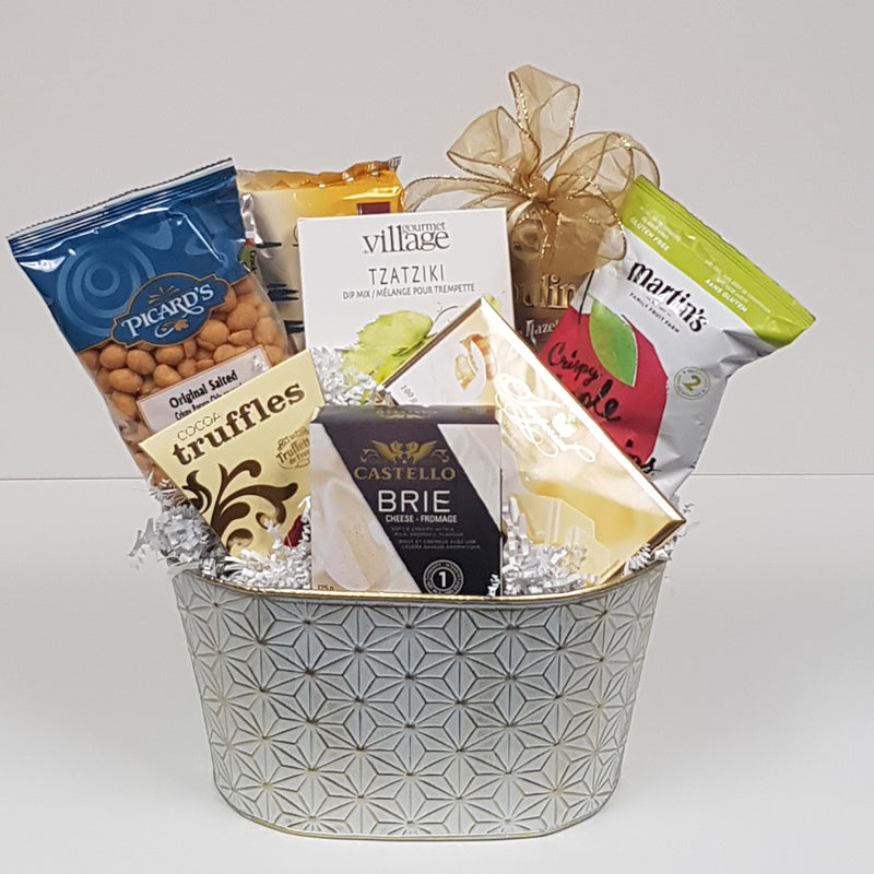 A tin filled with chocolates, truffles, apple chips, nuts, crackers, cheese, dip mix and biscuits.