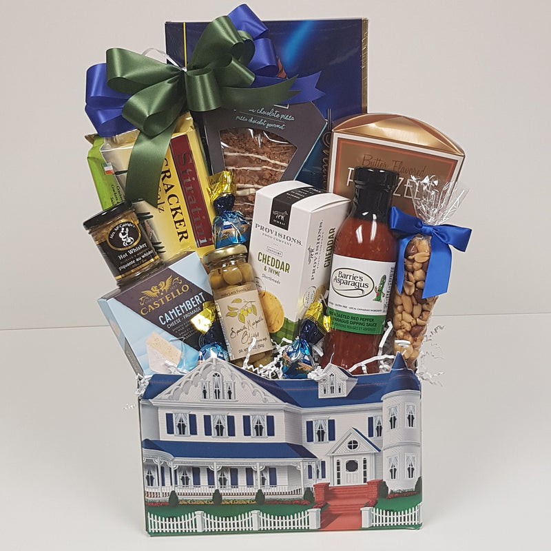 A house-shaped box with chocolate pizza, crackers, cheese, mustard, olives, shortbread, dipping sauce, nuts, pretzels, and more!