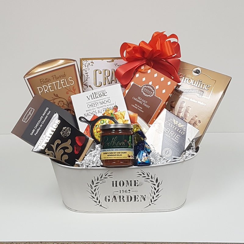 A tin filled with pretzels, wafer rolls, crackers, cheese, gourmet dip mix, truffles, chocolates, salsa and more.
