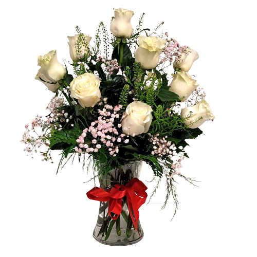 Floral arrangement of 12 white roses in clear glass vase.