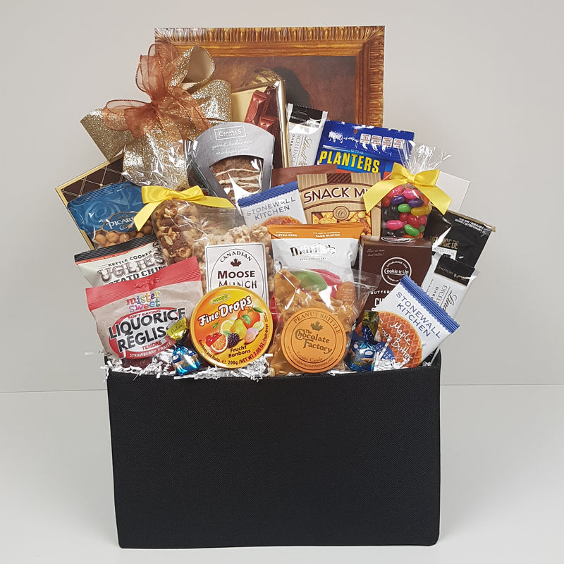 A cloth box filled with European chocolates, chocolate pizza, nuts, biscuits, jelly beans, peanut brittle, popcorn, candies and more.