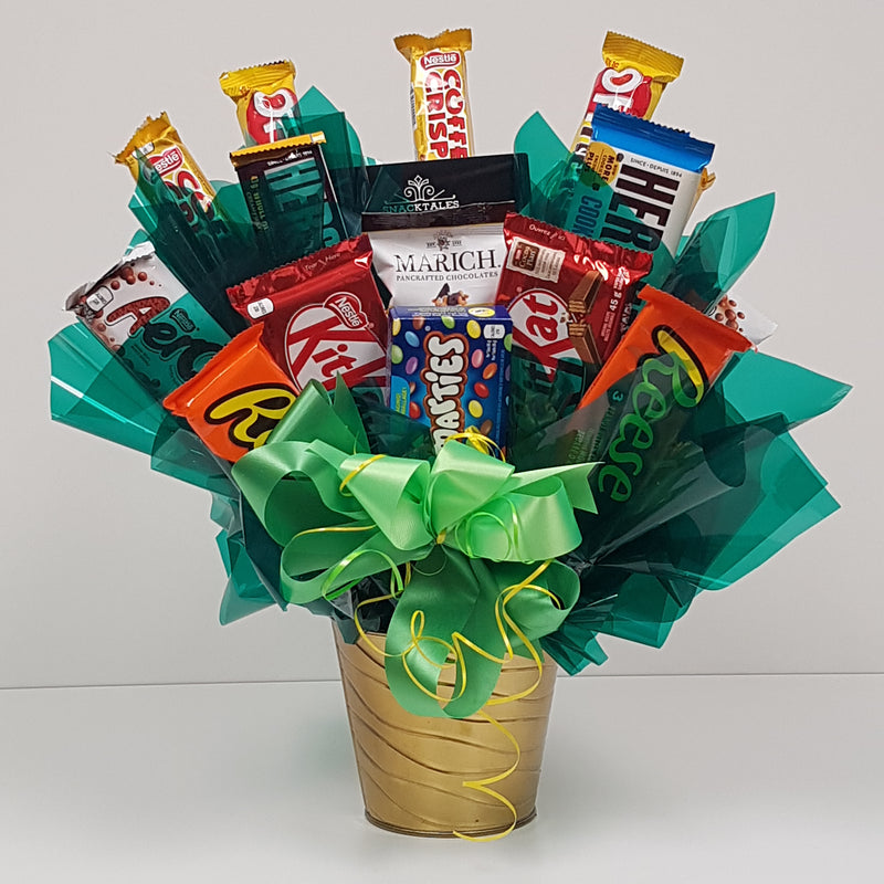 An assortment of classic chocolates, arranged as a bouquet in a tin.