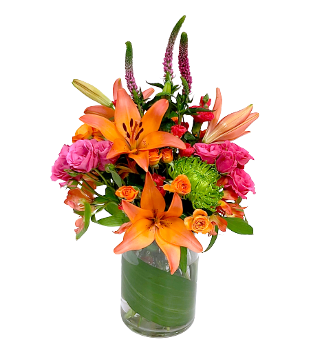 A stunning floral vase arrangement with lilies, veronica, spray roses and alstromeria in hues of bright orange, fuschia and green.