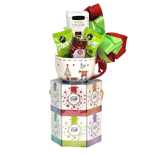 A tower of assorted teas, shortbread, jam, crackers and a mug.
