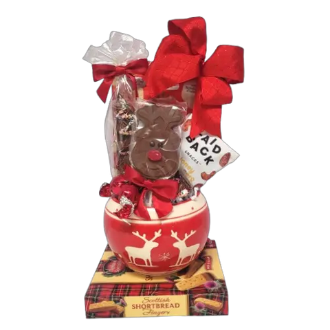 A Christmas candy bowl filled with lots of scrumptious treats. There's a chocolate lolly, tasty nuts, chocolate pretzels and biscuits too! 