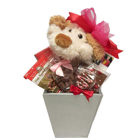 Beautiful gift basket tin filled with delectable sweet treats of truffles and chocolate assortments, roasted nuts, jelly beans and a cute plush puppy. 