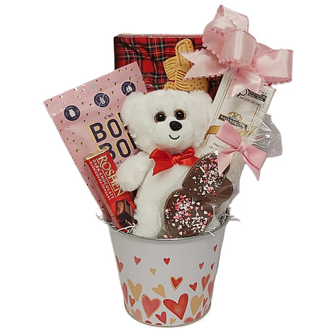 Valentine's tin designed with hearts and filled with assorted chocolates, gummies, shortbread and a teddy bear too.