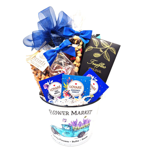 Flower market tin filled with biscotti, pretzels, truffles, trail mix, chocolate hearts and tea