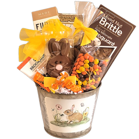 A bunny tin filled with lots of goodies, including brittle, fudge, pretzels, and assorted chocolates.