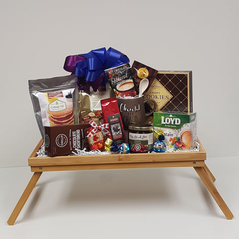 A breakfast tray loaded with flavoured hot chocolate, coffee, tea, a special mug, pancake mix and maple syrup, shortbread and biscuits and yummy "Pie in a Jar" dessert topping!
