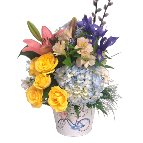 Flower arrangement designed in "Hello Spring" pot with roses, lilies, irises and hydrangea too. 
