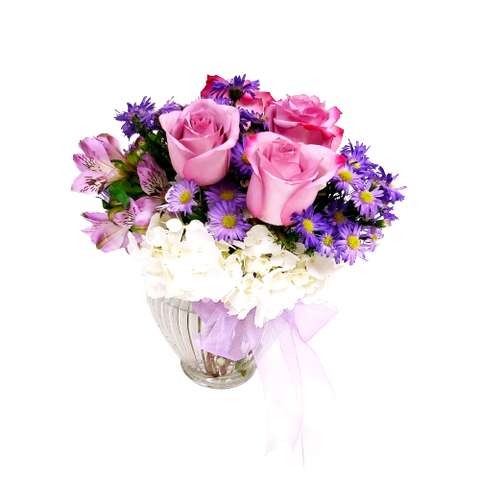Floral arrangement with soft coloured roses, hydrangea, asters and more.