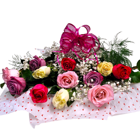 Perfect presentation style of one dozen soft coloured roses in pinks, lavender and cream.
