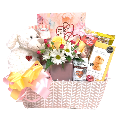 Pretty basket of a cute floral arrangement, a cuddly plush puppy or bear and sweet treats of chocolate, cookies, candies and more.