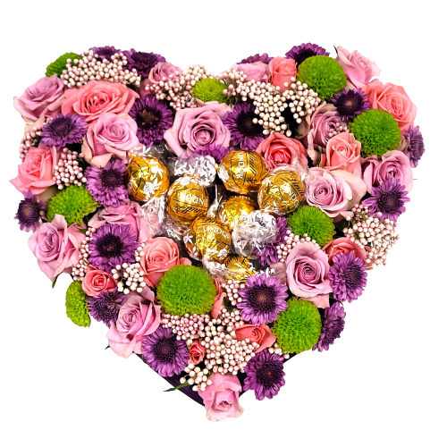Heart shaped floral design with pink and lavender roses, poms and asters topped with Lindt truffles.