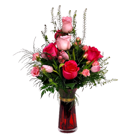 A bouquet of roses and tulips in a vase.