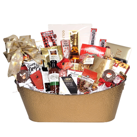 A large gold tin filled with sparkling apple cider, chocolate, crackers, cheese, cookies, pretzels, jam, pepperoni, salmon and many more gourmet delectables.